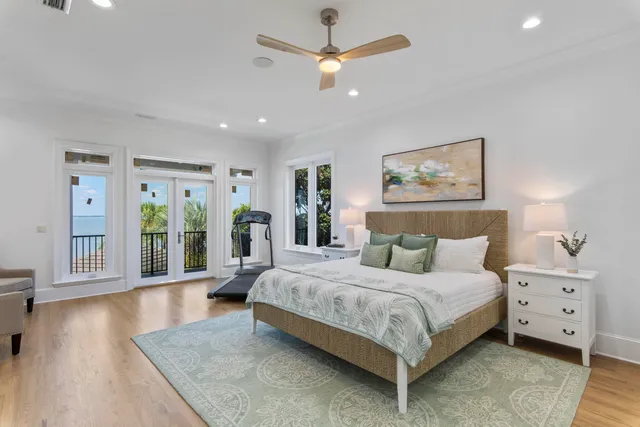 a bedroom with a large bed and a chandelier