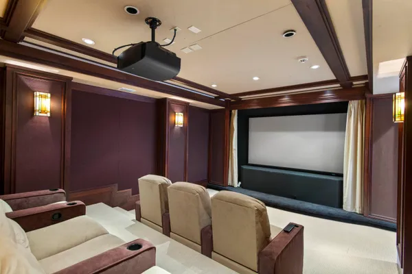 a living room with furniture and a projector screen