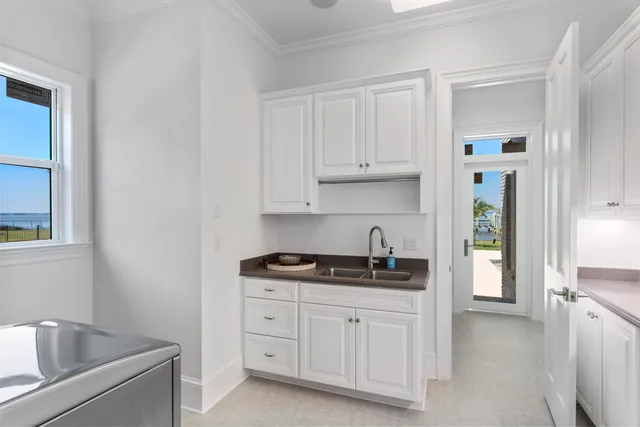 a kitchen with white cabinets and a sink