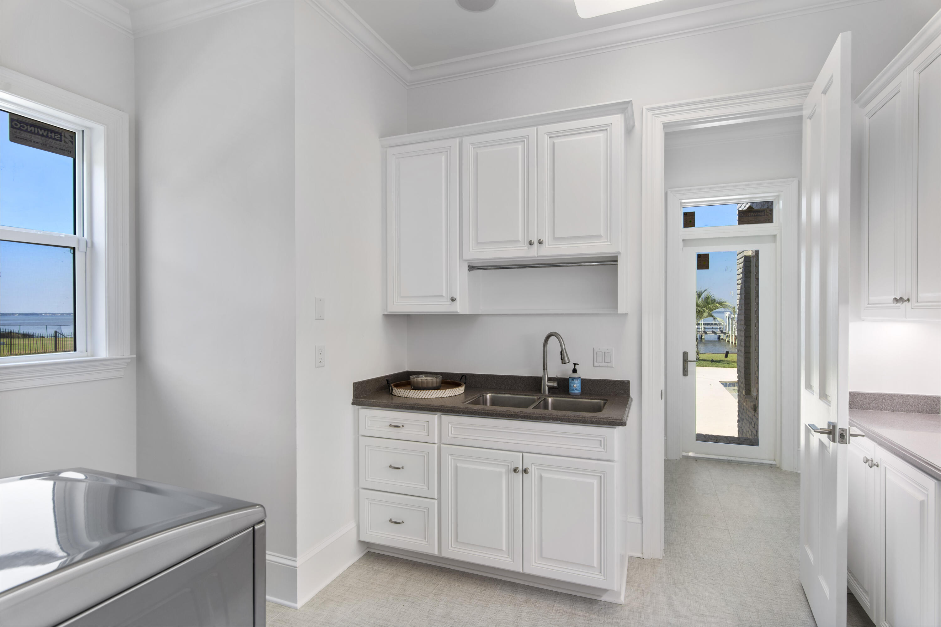 671 Driftwood Point Road Santa Rosa Beach, FL 32459 - Photo 36 of 41 a kitchen with white cabinets and a sink