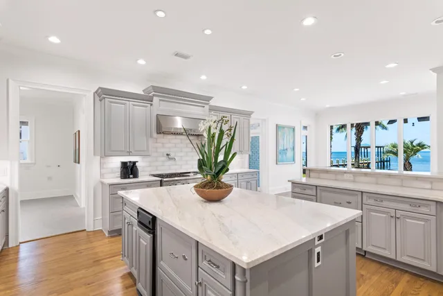 a kitchen with kitchen island a counter top space a sink stainless steel appliances and cabinets
