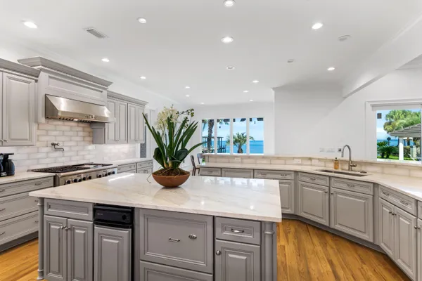 a kitchen with a sink a counter space and cabinets