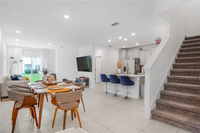 an aerial view of multiple houses with a yard