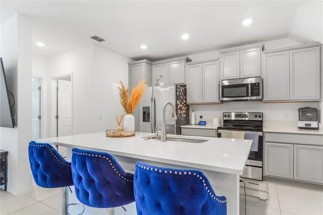 a green field with lots of trees in the background