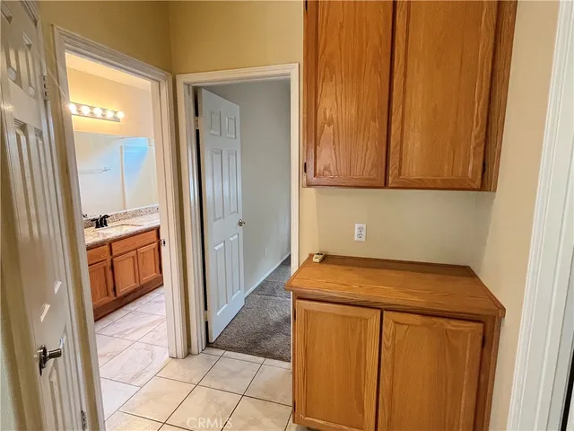 a utility room with wooden floor washer and dryer