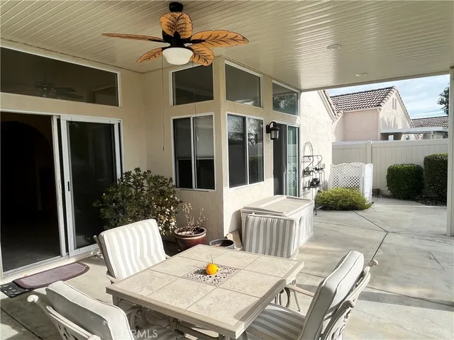 a view of a patio with a dining table and chairs