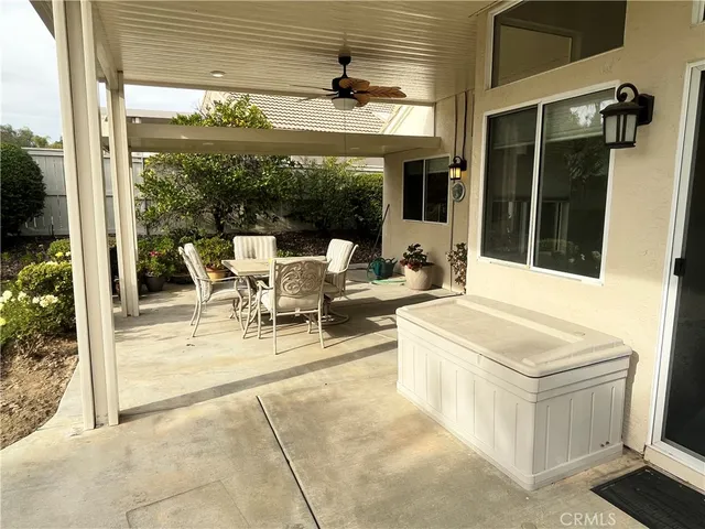 a view of a patio with table and chairs and potted plants