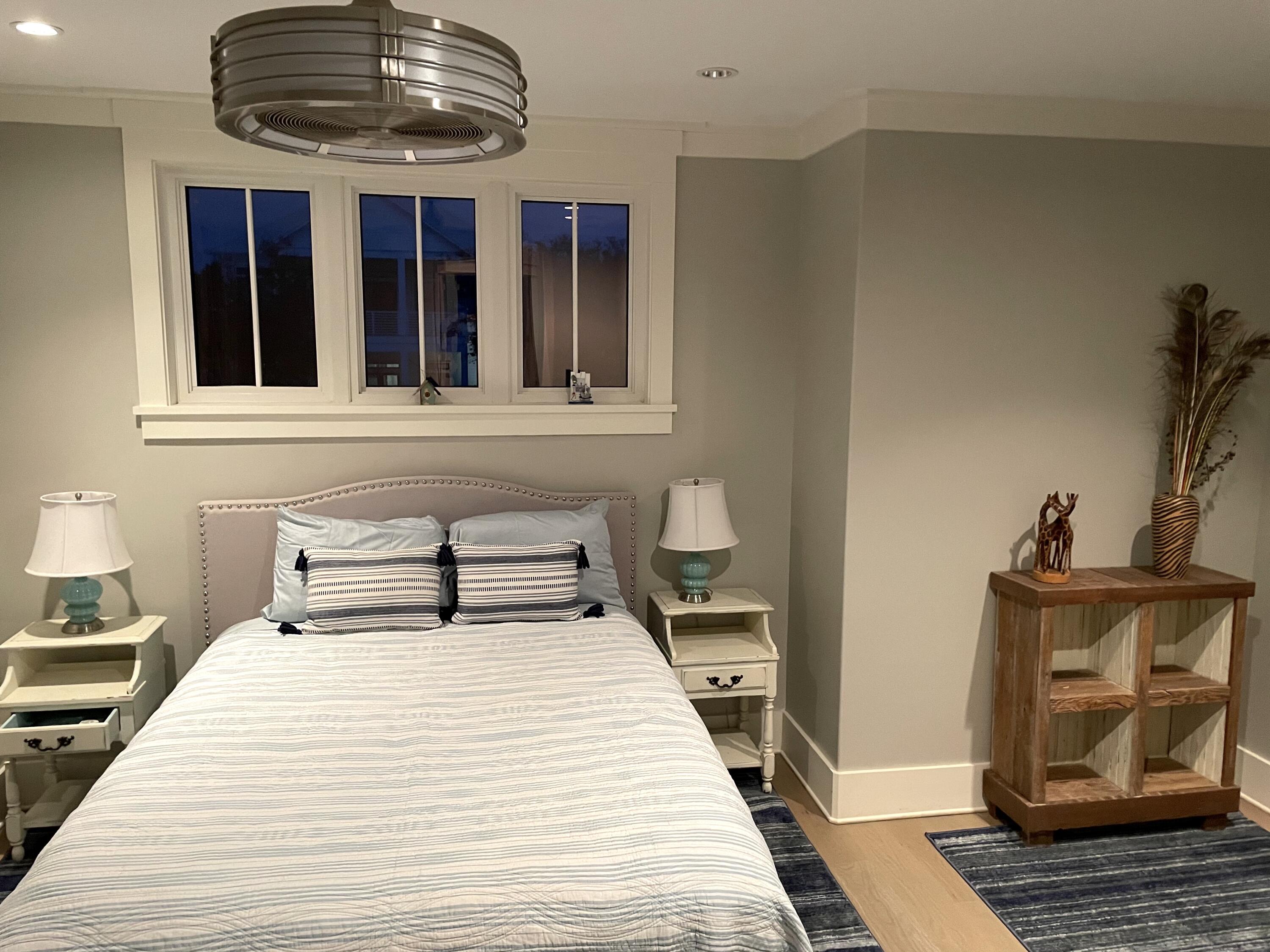 69 Brenda Lane Inlet Beach, FL 32461 - Photo 38 of 46 a bedroom with a large bed and a chandelier