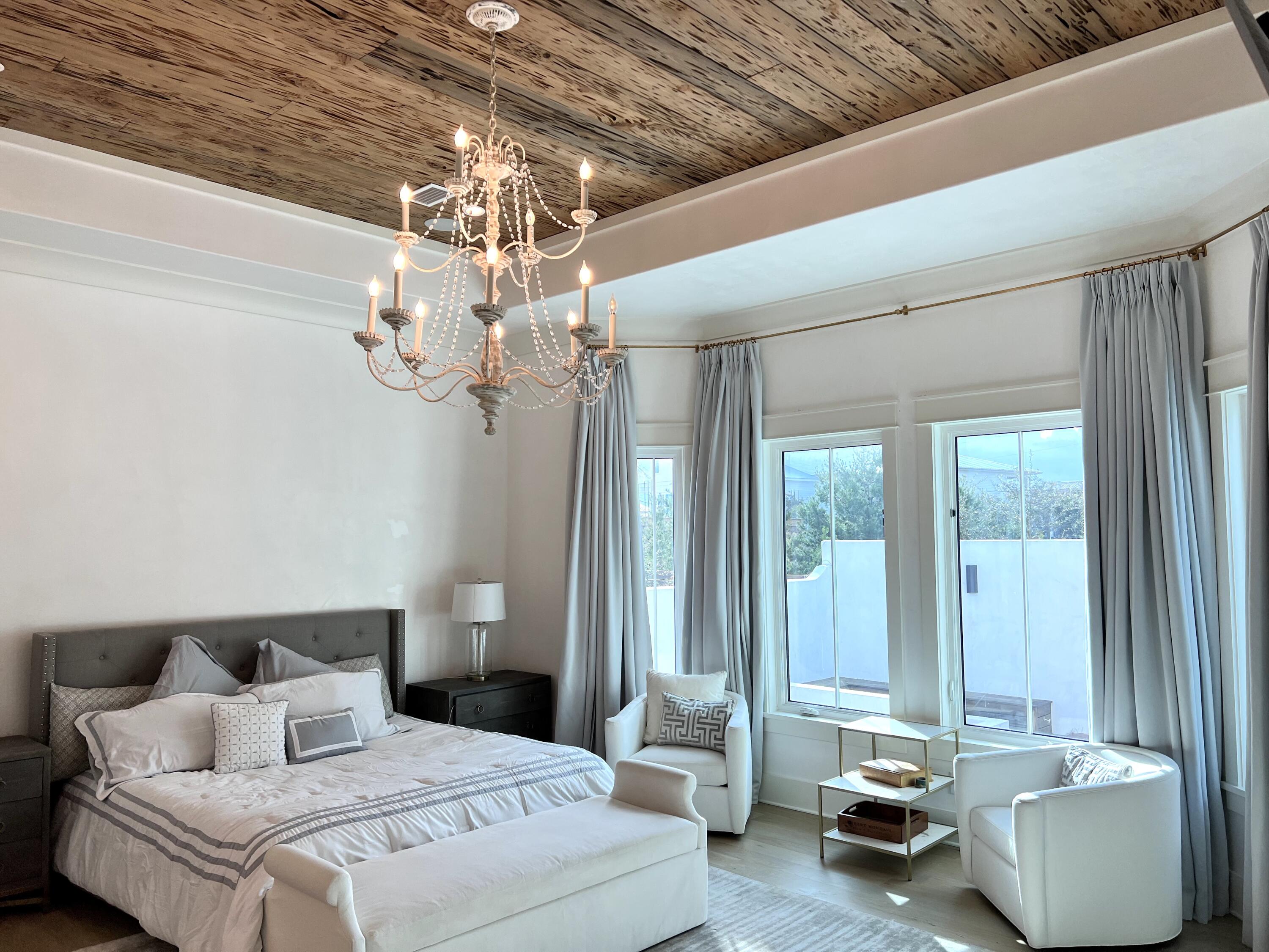 69 Brenda Lane Inlet Beach, FL 32461 - Photo 8 of 46 a bedroom with a bed and a chandelier