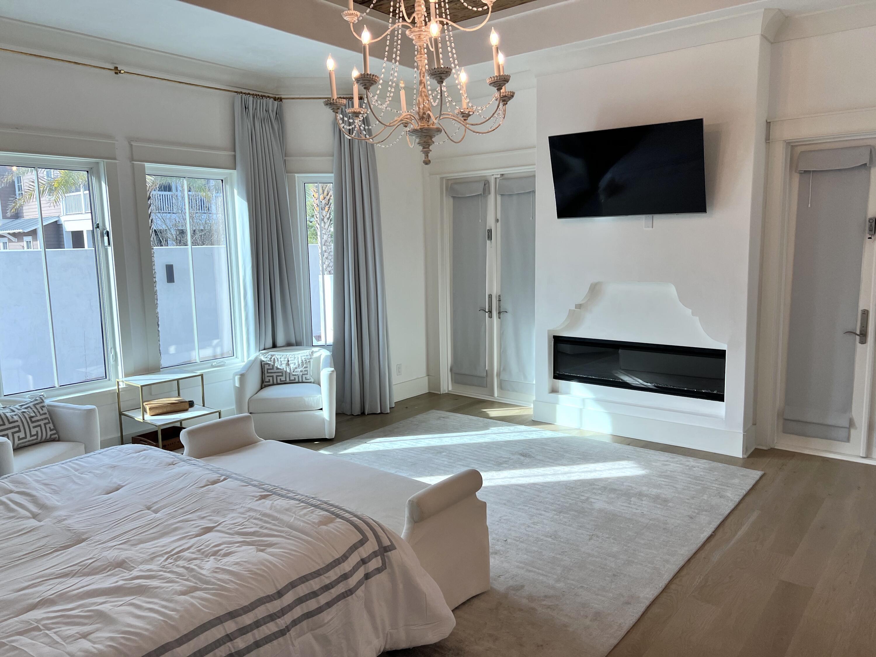 69 Brenda Lane Inlet Beach, FL 32461 - Photo 9 of 46 a spacious bedroom with a bed and a flat screen tv