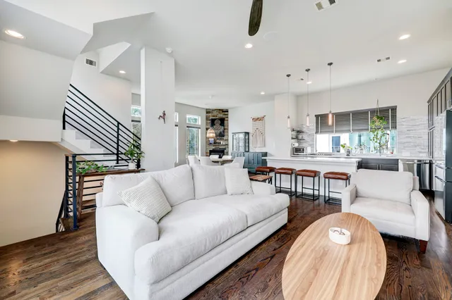 a living room with furniture and a wooden floor