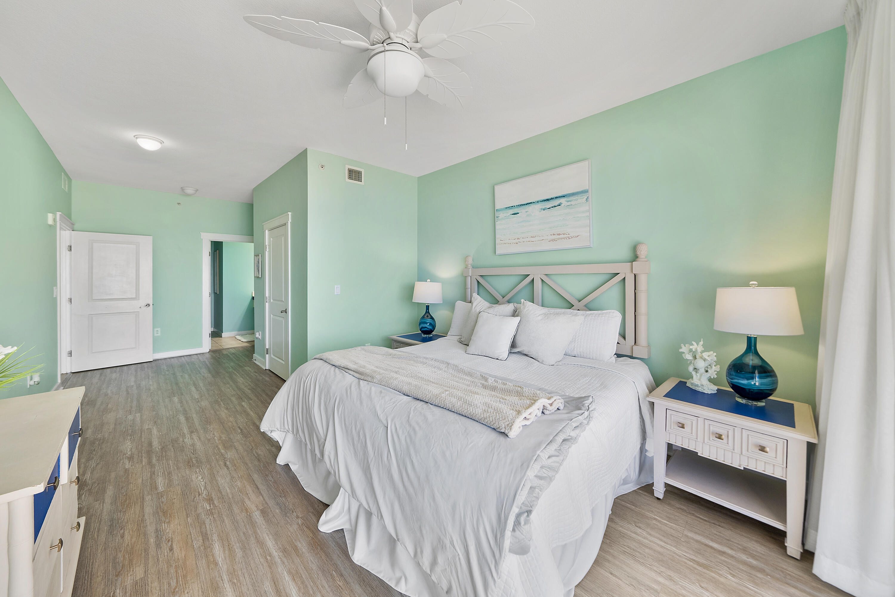 15100 Front Beach Road, Unit 1604 Panama City Beach, FL 32413 - Photo 19 of 66 a spacious bedroom with a bed and a dresser
