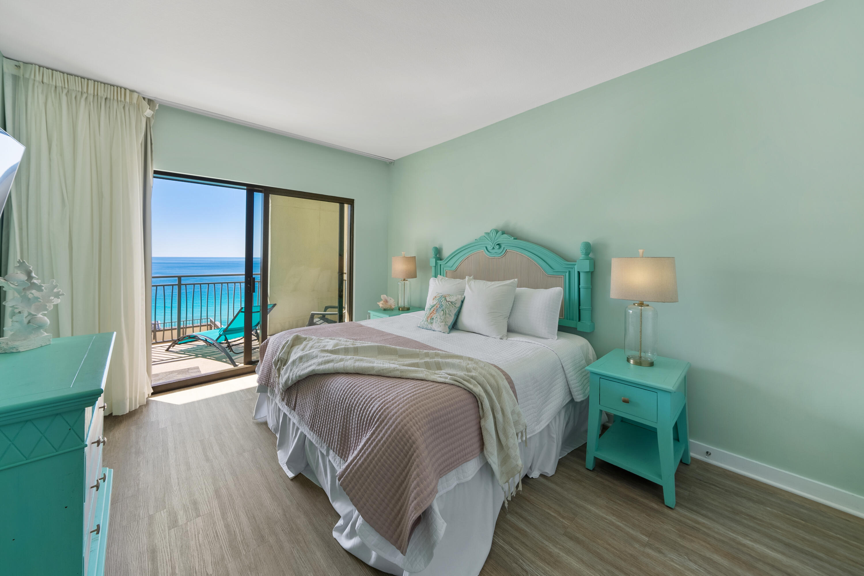 15100 Front Beach Road, Unit 1604 Panama City Beach, FL 32413 - Photo 23 of 66 a bedroom with a bed and wooden floor