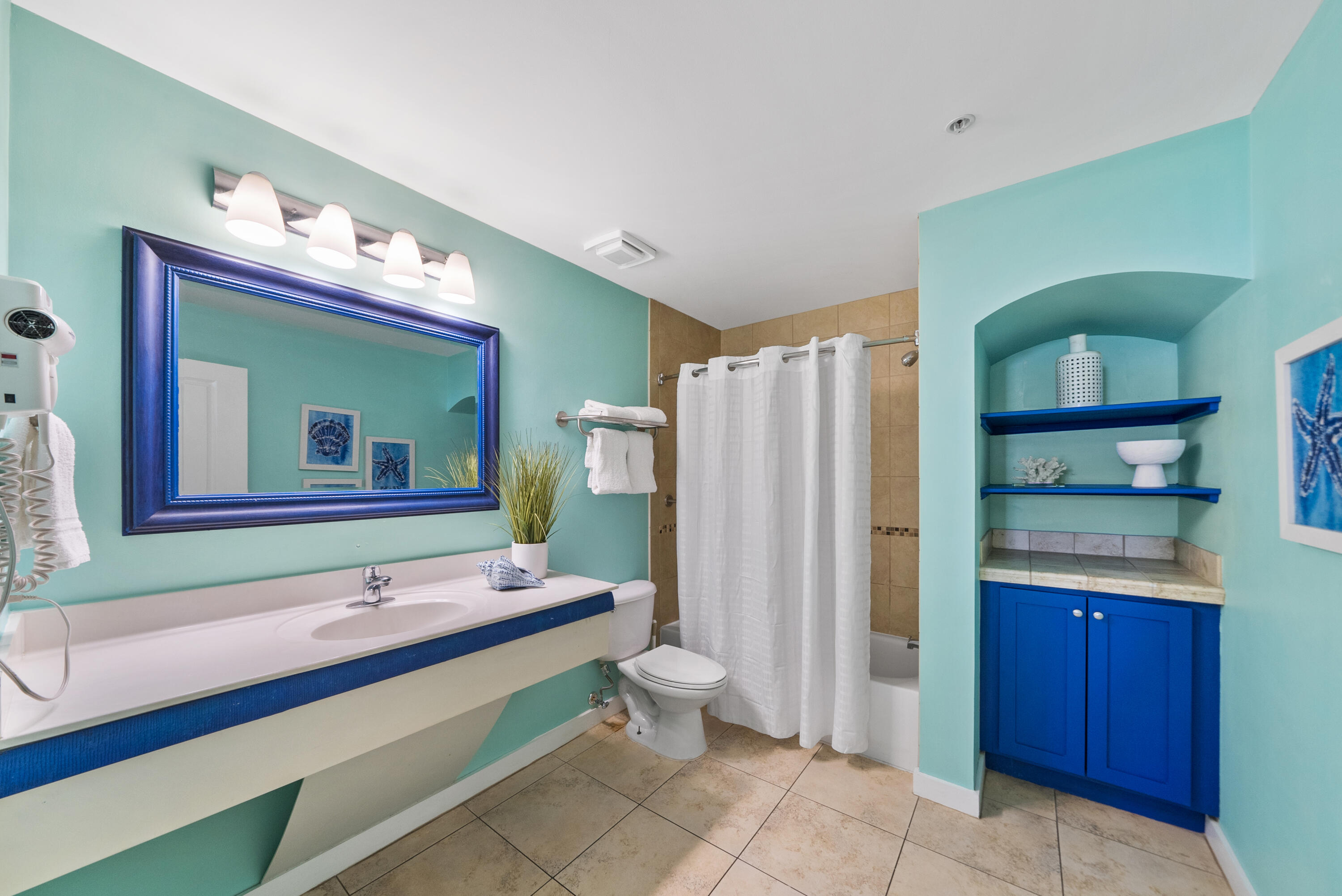 15100 Front Beach Road, Unit 1604 Panama City Beach, FL 32413 - Photo 41 of 66 a bathroom with a double vanity sink and a mirror