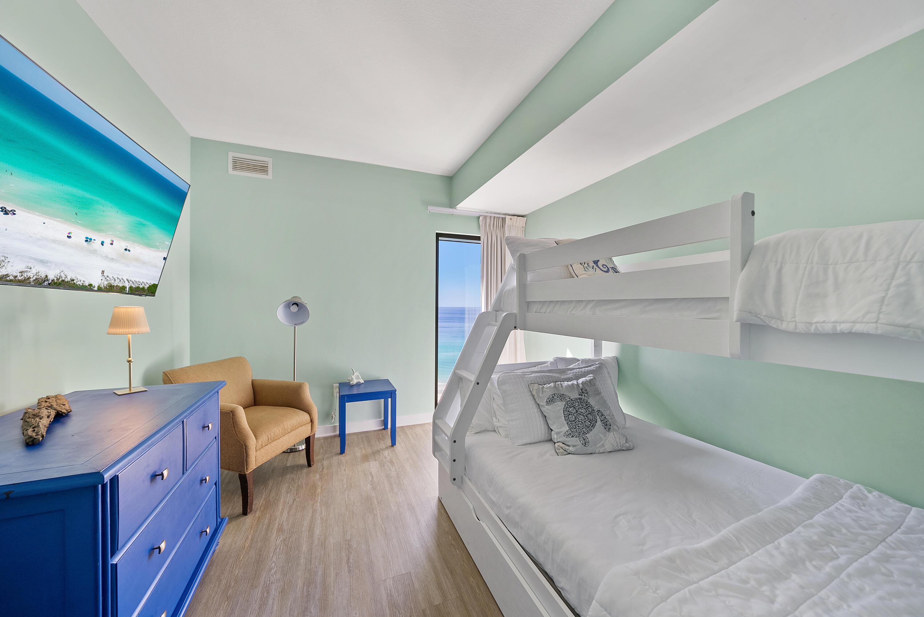 15100 Front Beach Road, Unit 1604 Panama City Beach, FL 32413 - Photo 42 of 66 a bedroom with a bed and wooden floor