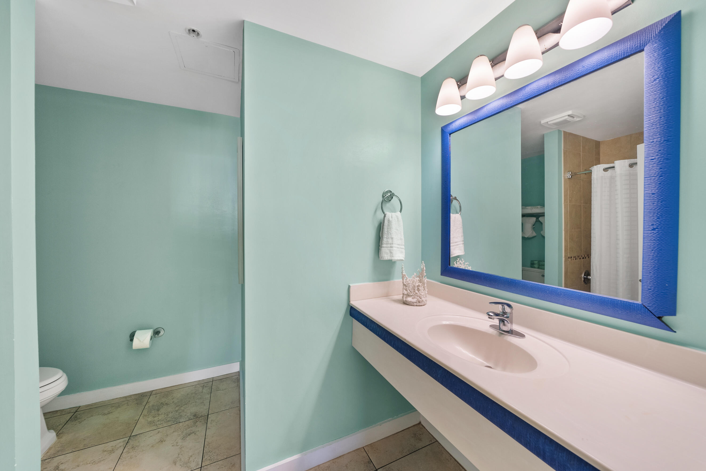 15100 Front Beach Road, Unit 1604 Panama City Beach, FL 32413 - Photo 49 of 66 a bathroom with a sink and a mirror