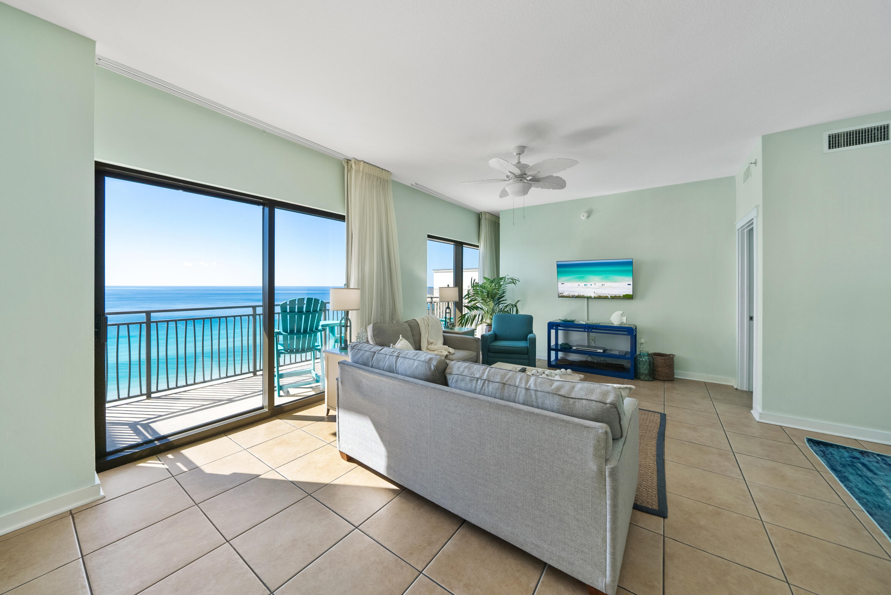 15100 Front Beach Road, Unit 1604 Panama City Beach, FL 32413 - Photo 8 of 66 a living room with furniture and a floor to ceiling window