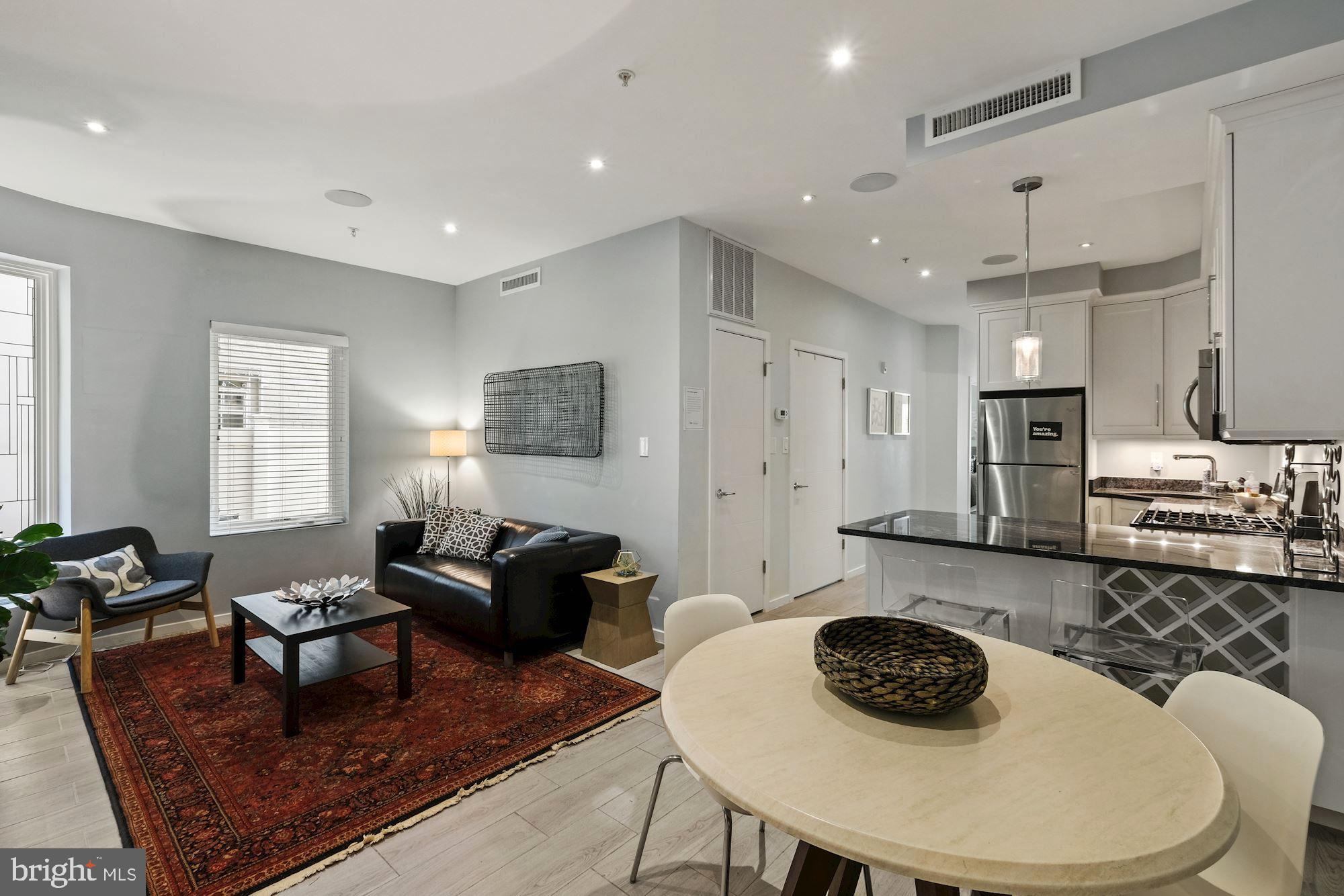 756 Park Road Northwest, Unit 2 Washington, DC 20010 - Photo 1 of 48 a living room with furniture and a wooden floor