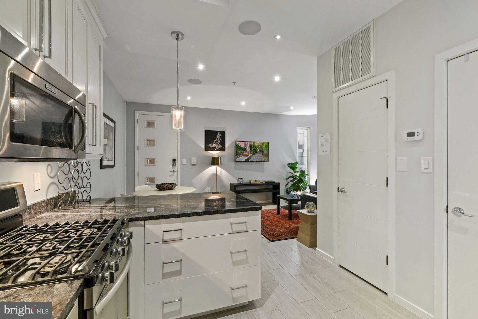 756 Park Road Northwest, Unit 2 Washington, DC 20010 - Photo 12 of 48 a kitchen with counter top space cabinets and stainless steel appliances