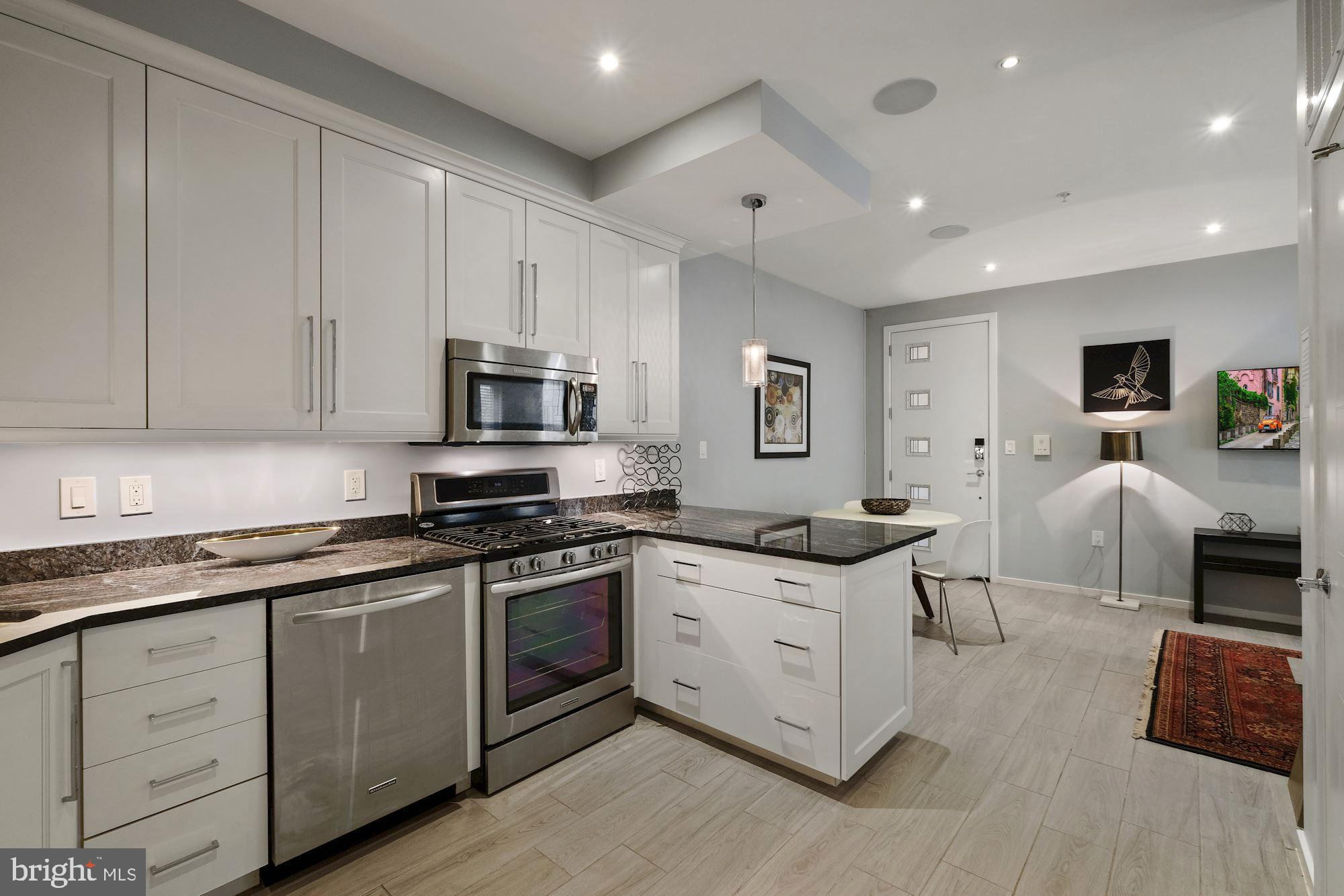756 Park Road Northwest, Unit 2 Washington, DC 20010 - Photo 13 of 48 a kitchen with stainless steel appliances granite countertop a stove a sink a refrigerator and white cabinets