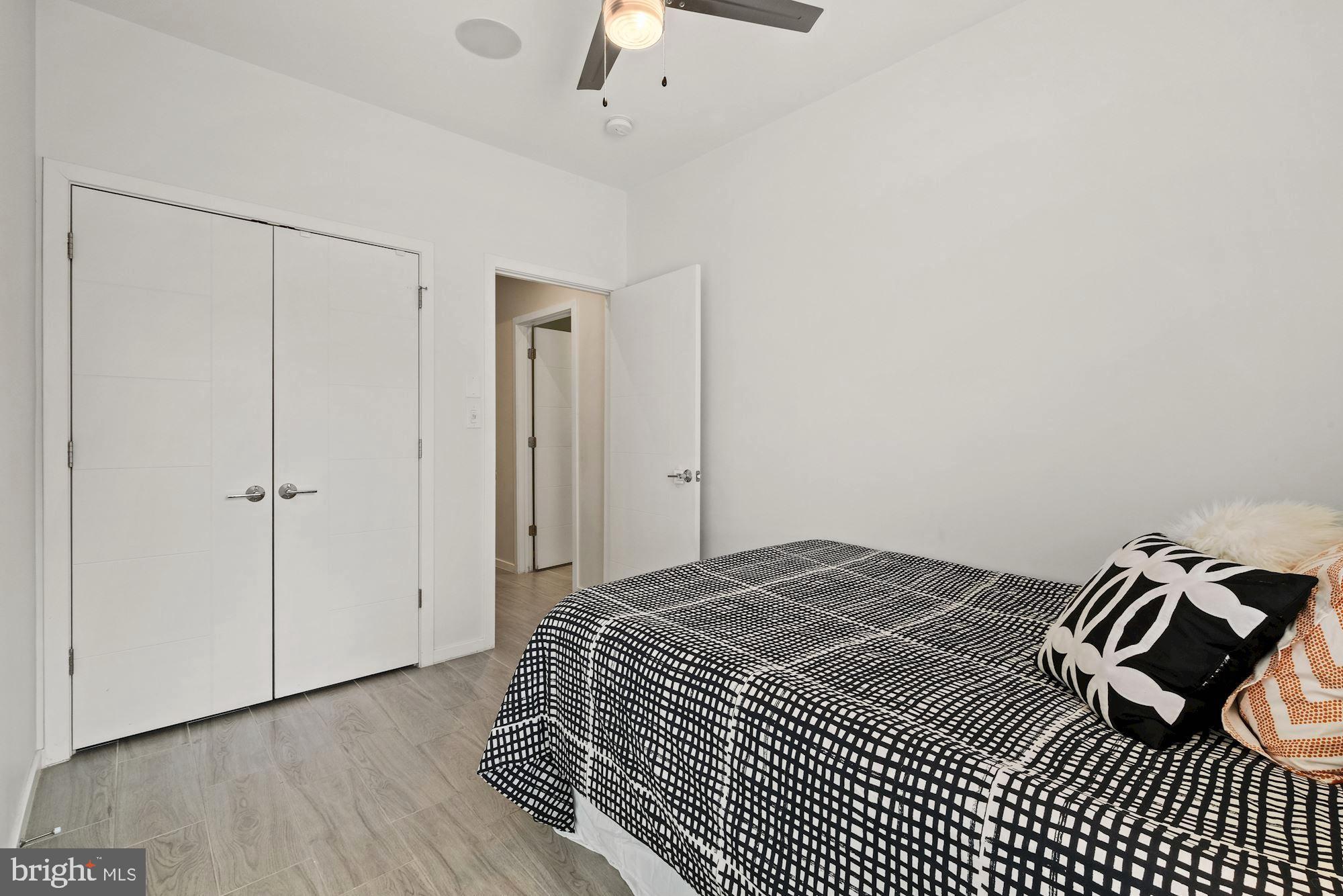 756 Park Road Northwest, Unit 2 Washington, DC 20010 - Photo 17 of 48 a bedroom with a bed and a ceiling fan