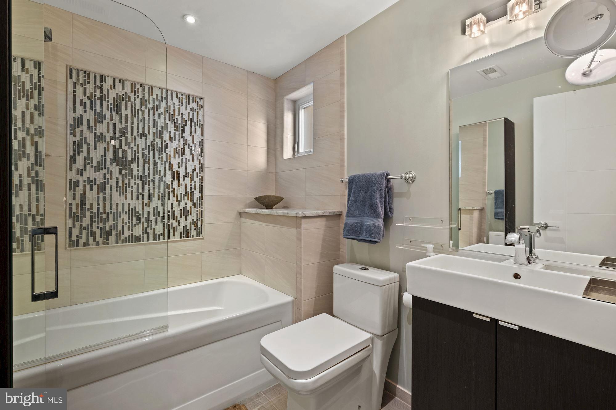 756 Park Road Northwest, Unit 2 Washington, DC 20010 - Photo 23 of 48 a bathroom with a sink a toilet and shower