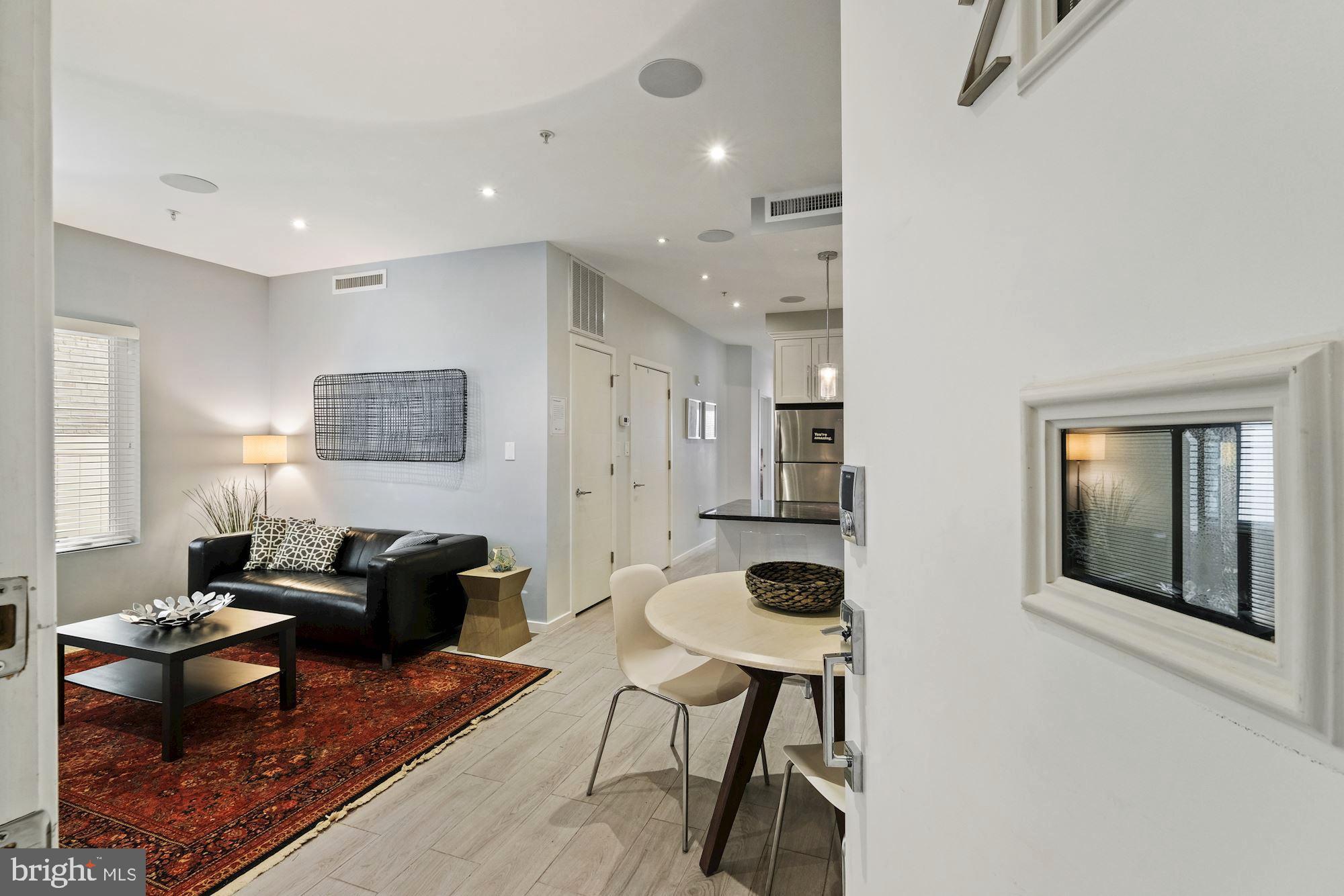 756 Park Road Northwest, Unit 2 Washington, DC 20010 - Photo 4 of 48 a living room with furniture and a flat screen tv