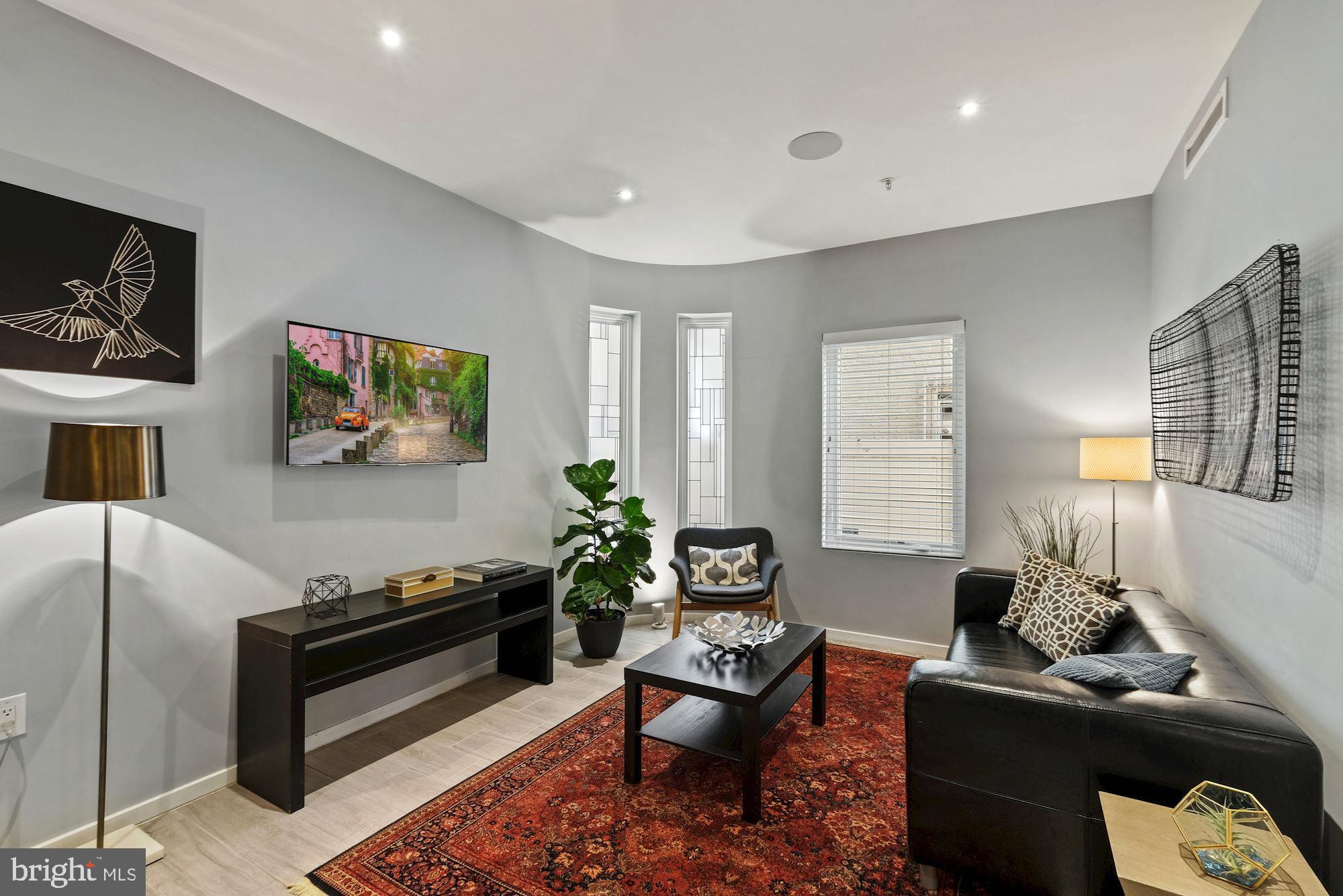 756 Park Road Northwest, Unit 2 Washington, DC 20010 - Photo 6 of 48 a living room with furniture and a flat screen tv