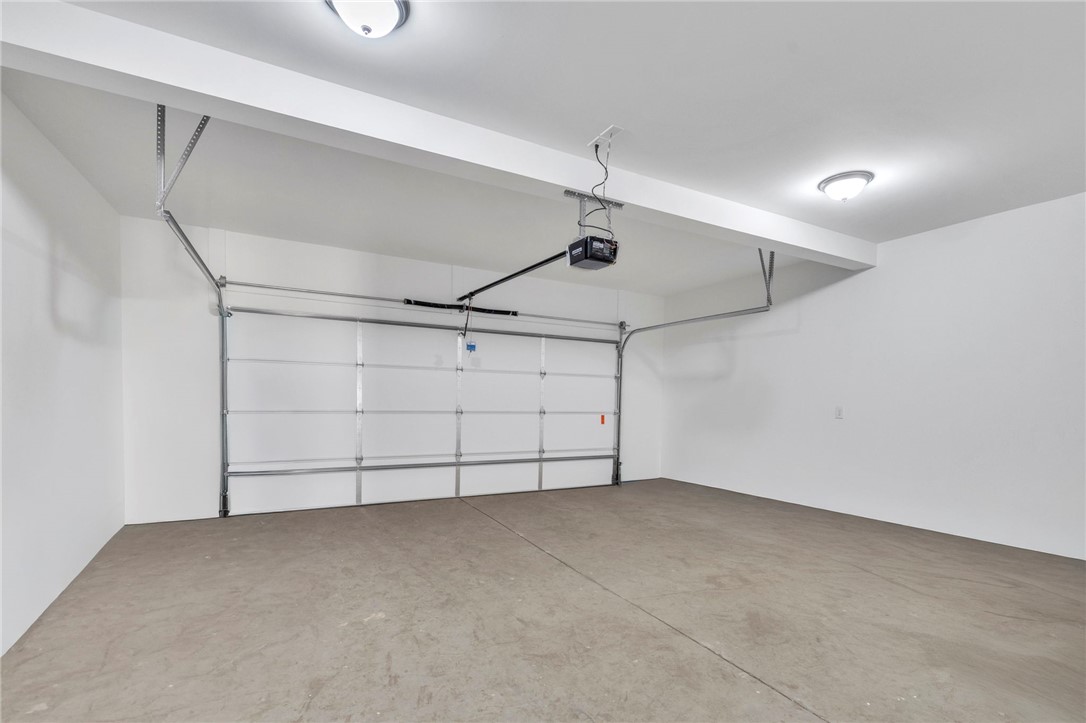 2009 Aberdeen Lane Walhalla, SC 29691 - Photo 12 of 43 This spacious garage offers ample room for vehicles and storage, featuring a durable concrete floor.