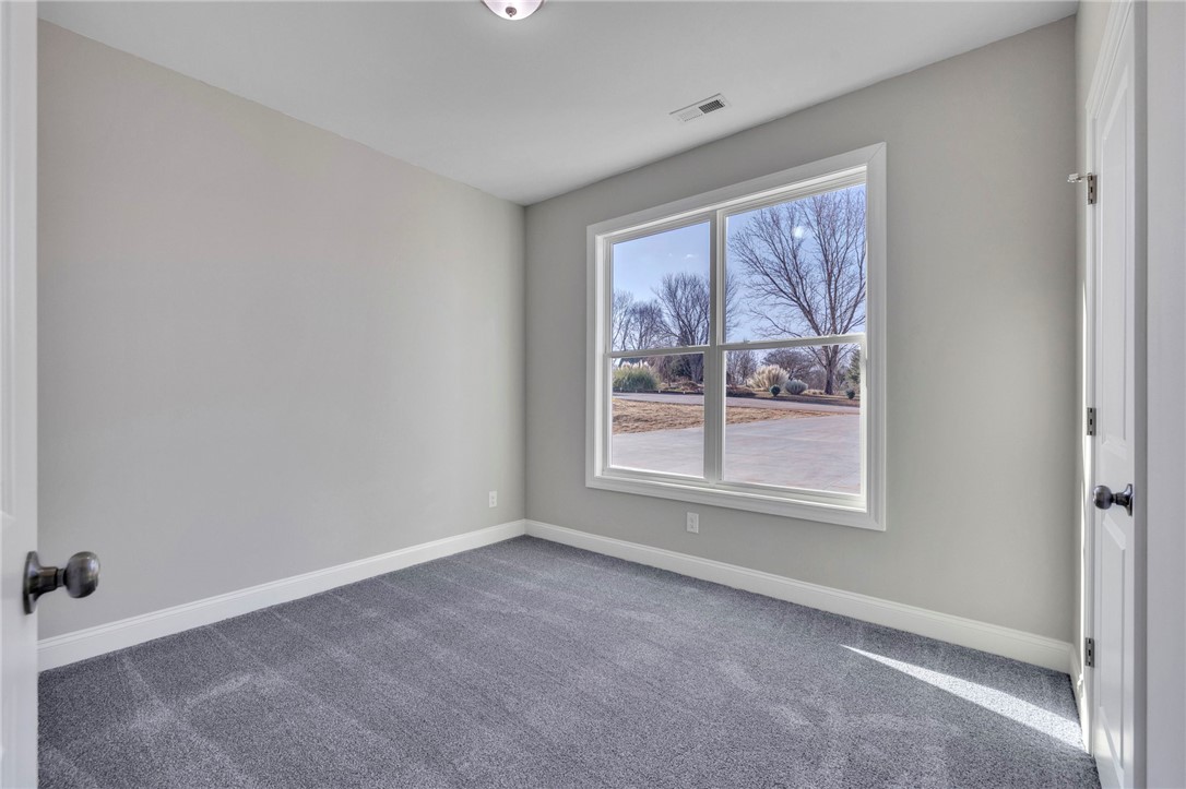 2009 Aberdeen Lane Walhalla, SC 29691 - Photo 14 of 43 This cozy bedroom features plush carpet and an expansive window, offering a serene view of the outdoors.