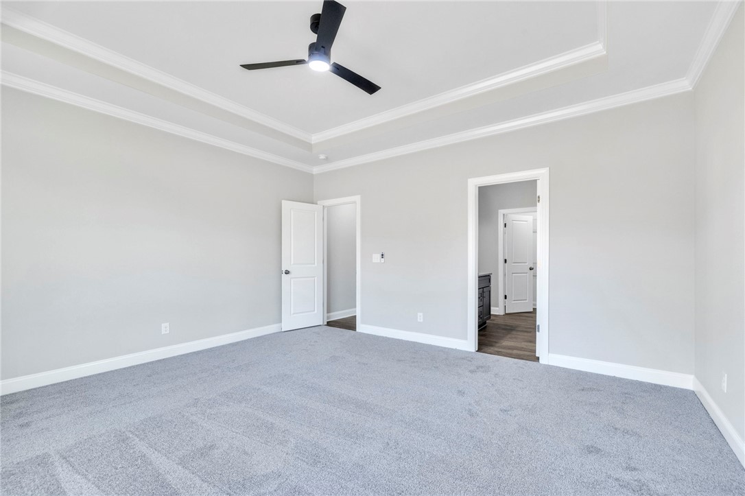 2009 Aberdeen Lane Walhalla, SC 29691 - Photo 20 of 43 This spacious bedroom features elegant crown molding and soft carpet, offering comfort.