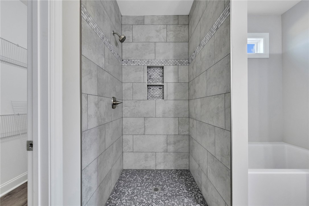 2009 Aberdeen Lane Walhalla, SC 29691 - Photo 23 of 43 This modern shower with sleek tile and a pebble floor offers a refreshing retreat.