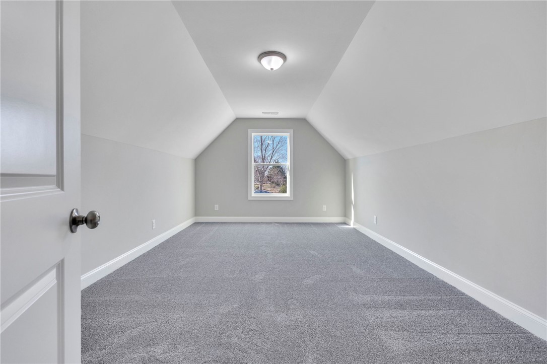 2009 Aberdeen Lane Walhalla, SC 29691 - Photo 25 of 43 Bright attic space featuring a large window and plush carpet, ready for your creative vision.