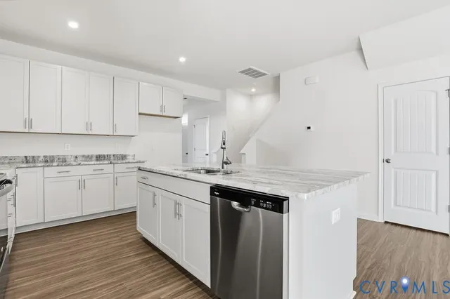 a kitchen with a sink stove and cabinets