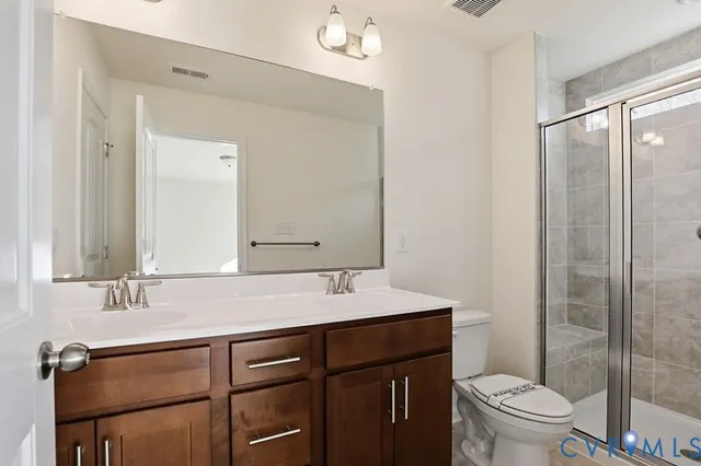 a bathroom with a shower a toilet and a sink