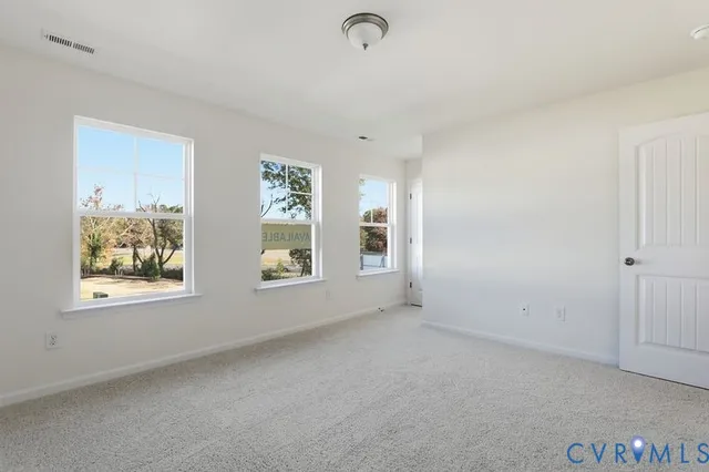 an empty room with a window and stainless steel appliances