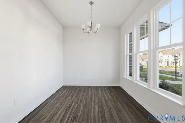a view of a room with wooden floor and windows