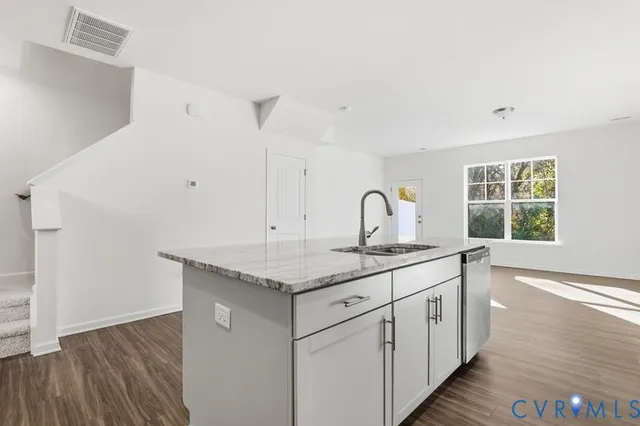 a kitchen with a sink and cabinets