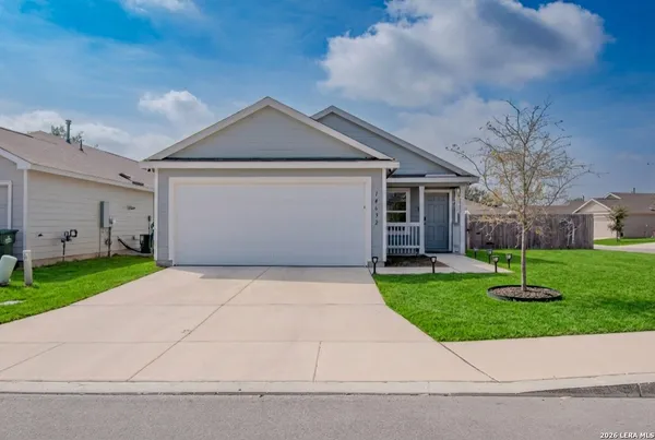a front view of house with yard and green space