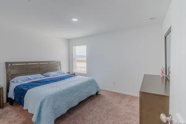 a bedroom with a bed and window