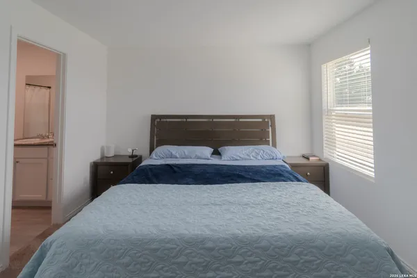 a room with a bed and a dresser