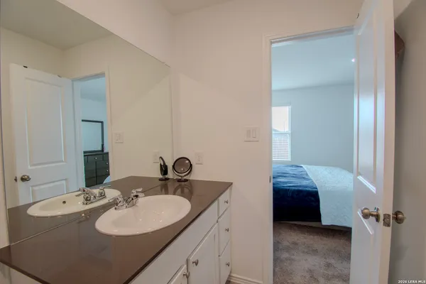 a bathroom with a sink a toilet and a mirror