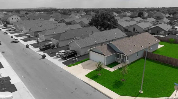 an aerial view of a house with a garden and trees