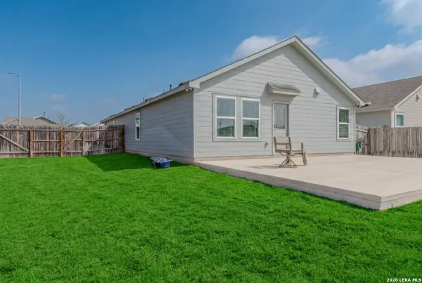 a view of a house with backyard and sitting area