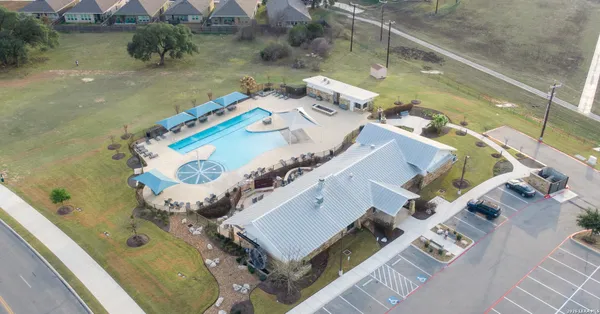 an aerial view of a house with a swimming pool