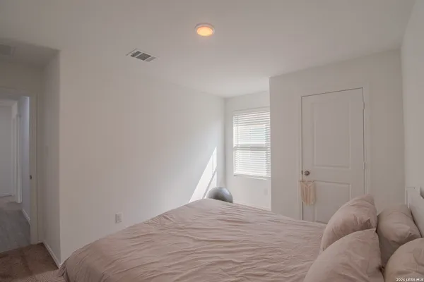 a bedroom with a bed and window