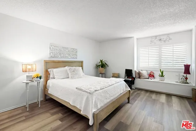 a bedroom with a bed and windows