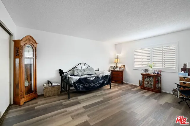a bedroom with furniture and a window