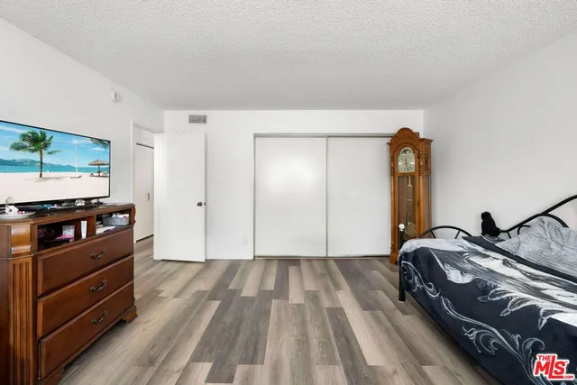 a bedroom with a bed and a flat screen tv