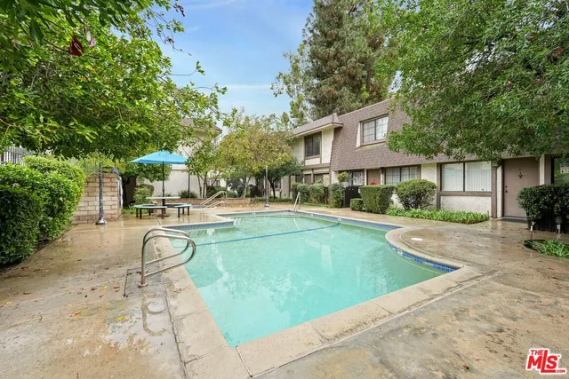 a swimming pool with outdoor seating and yard